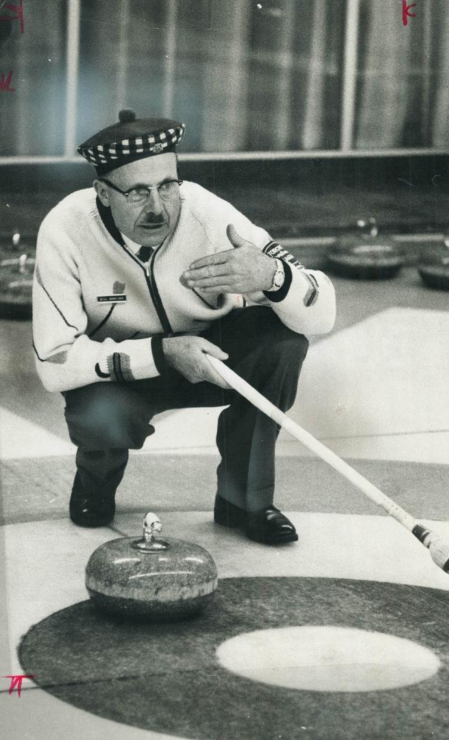 Curling in 1966, skip William Dennison indicates to a teammate where he wants the stone to go