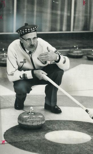Curling in 1966, skip William Dennison indicates to a teammate where he wants the stone to go