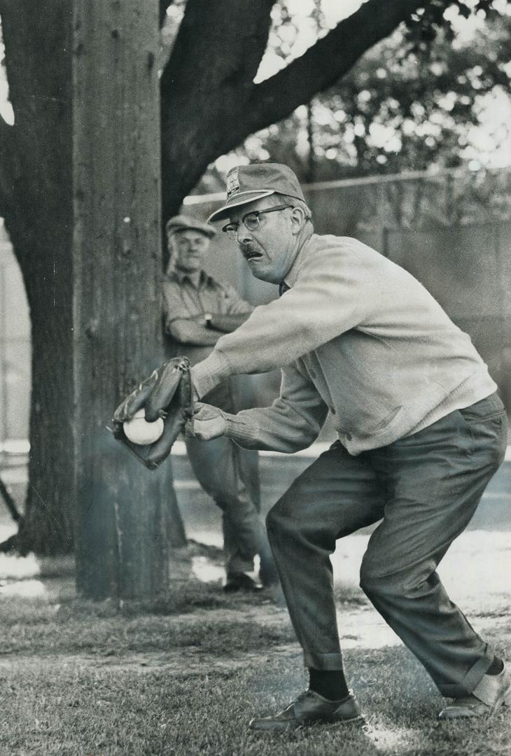 Mayor Dennison fields one. Mayor William Dennison, who's retiring at the end of the year, makes a catch in the third annual softball game between city(...)