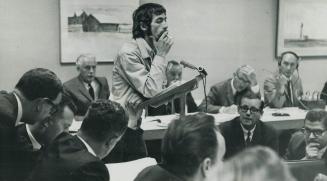 Happie spokesman David DePoe leans on speaker's rostrum at City Hall yesterday trying to persuade city works committee to close Yorkville Ave. on a tr(...)