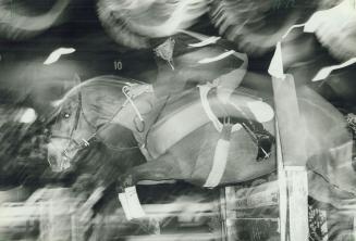 A royal leap. Box Car Willie shows fine form as he and rider Mario Deslaurlers take a jump in yesterday's competiton for the McKee Open Jumper Trophy (...)