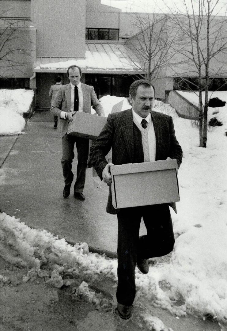 Police raid: Constables Mark Brown, left, and John Taylor remove documents from Town of Vaughan offices of Councilors Nick Di Giovanni and Councillor Frank Cipollone