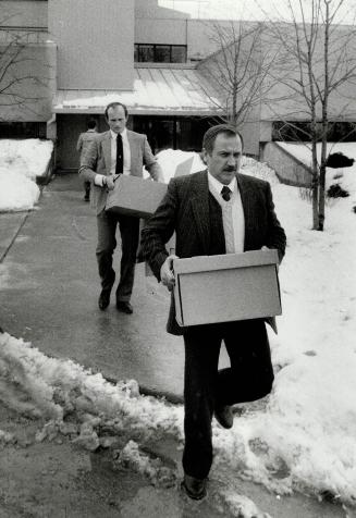 Police raid: Constables Mark Brown, left, and John Taylor remove documents from Town of Vaughan offices of Councilors Nick Di Giovanni and Councillor Frank Cipollone