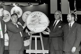 Shiny new quarters. Paul Dick, left, Minister responsible for the Royal Canadian Mint, unveils the Ontario coin in the Canada 125 series yesterday at (...)