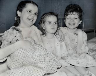 Happy and smiling, the three Dickerson children, Constance, 18, Glenda, 13, and Gordon, 14, pose in Windsor hospital