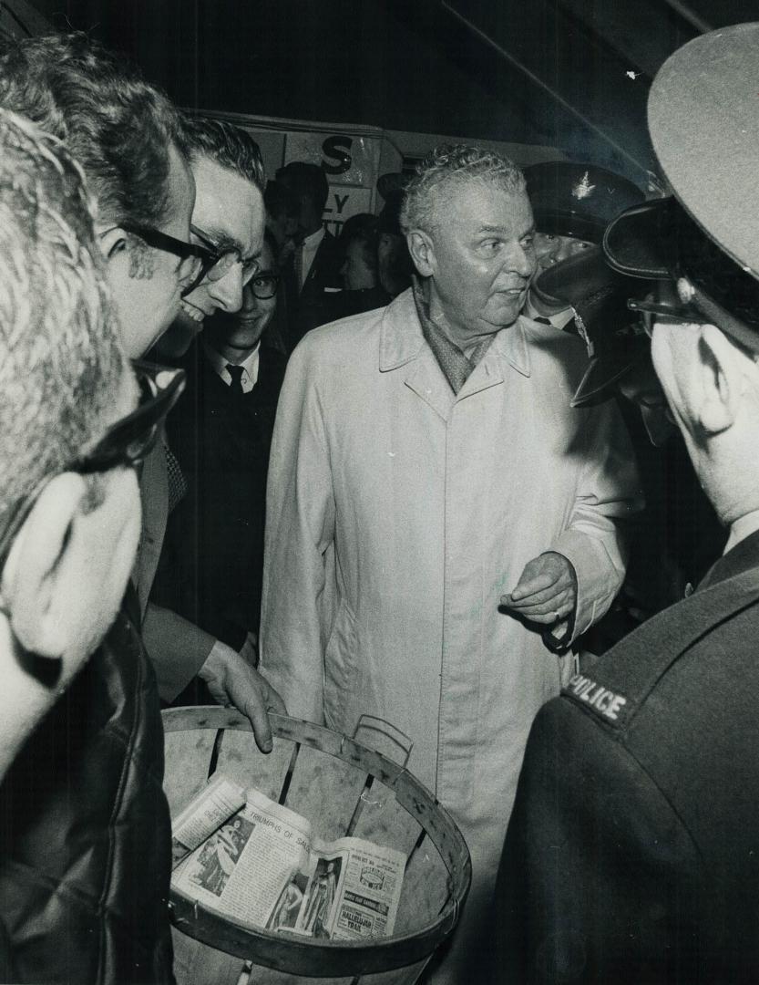 Basket for Donations to the Tory election campaign is ignored by Diefenbaker as he exchanges greeting with supporters crowding around him. The opposit(...)