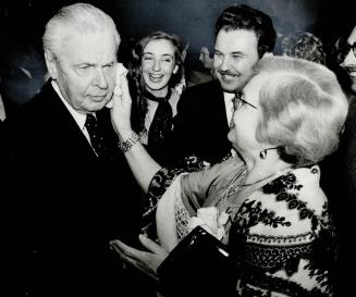 Election smear. Maria Maruszczak wipes lipstick smear from former prime minister John Diefenbaker's cheek as Parkdale-High Park Tory candidate Yu Shymko and daughter Lisa, 17, watch. [Incomplete]
