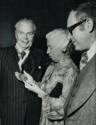 Former prime minister John Diefenbaker shows Eleanor Roosevelt Humanities Award to Ellen Fairclough, a former minister in his government, as Conservative MP Robert Coates looks on