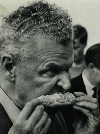 Corn-fed Conservative is Opposition Leader John Diefenbaker as he ties into a juicy cob at a Tory picnic Saturday in Oakville's Coronation Park. Diefe(...)