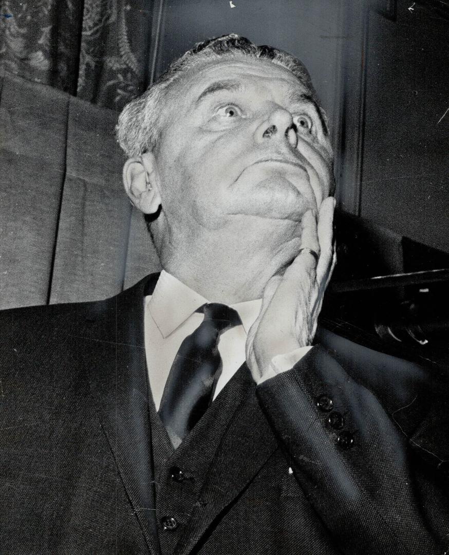 Tanned after his Bahamas vacation, Diefenbaker holds chin at rally of P