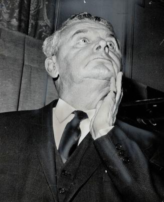 Tanned after his Bahamas vacation, Diefenbaker holds chin at rally of P