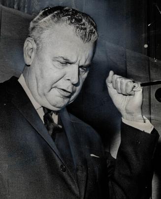 Fighting gesture, with clenched fist, is made by Diefenbaker
