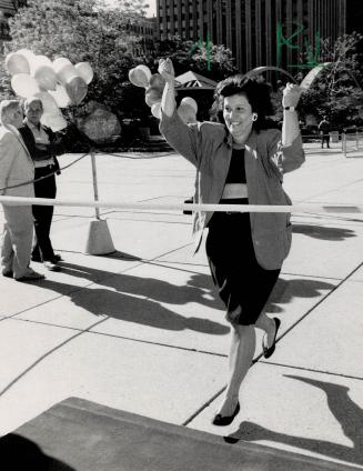 Alderman Betty Disero crosses the finish line first in a race with other politicians to city hall this morning using various modes of transportation f(...)