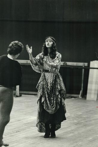 A dancer forms a mad shadow in background as Ann Ditchbun takes rehearsal break during work on revival of Mad Shadows