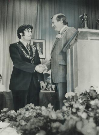 The first mayor of Mississauga, Dr. Martin Dobkin, is congratualted by Premier William Davis at the ceremonial inauguration yesterday in Glenforest Se(...)