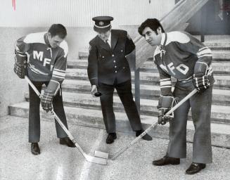 Facing off for charity. A hockey player in high school and university, Mississauga Mayor Martin Dobkin (right) faces off against fireman Dwight Larkin(...)