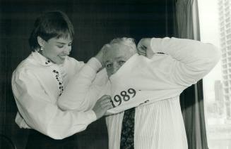 Sweating it out: A perfect fit? Recently retired national basketball coach Jack Donohue squeezed into a sweat-shirt bearing the Year of the Coach slogan, with a little help from diver Sylvie Bernier