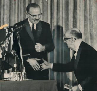 Bargain is sealed with a handshake at Montreal Mayor Jean Drapeau's press conference at the Royal York today where Drapeau won Mayor William Dennison'(...)