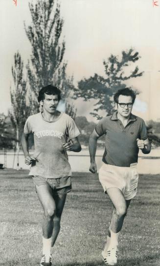 One of Canada's best hopes for an Olympic gold medal, marathon champion Jerome Drayton (left) gives Star writer Frank Jones a running interview as he (...)