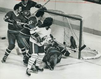 Just for good luck. Buffalo Sabres' Brian Spencer lifts the puck into the Montreal net over prone Canadiens' goalie Ken Dryden, but it was just to mak(...)