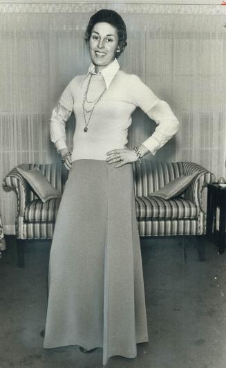 Mrs. Alan Eagleson, of Clarkson, will party in long camel wool skirt, camel blouse, shortsleeved pastel blue sweater and gold necklace