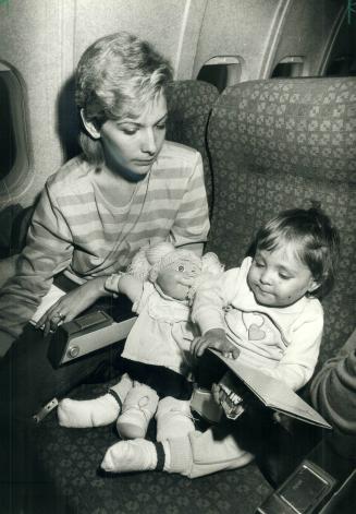 Two-year-old Lindsay Eberhardt, who is dying from liver failure, settles into her airplane seat as she and her mother Christine prepare to leave Toron(...)