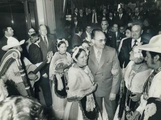 Mexican President Luis Echeverria is surrounded by dancers from Vera Cruz, Mexico, on his arrival at the Royal York Saturday. Echeverria addressed a l(...)