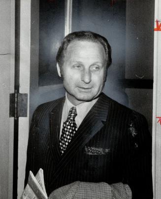 Major Figures in the Duke inquiry, Daniel Gasbarrini (left) and Donald (Red) LeBarre leave yesterday's session, LeBarre giving a peace sign to newsmen(...)