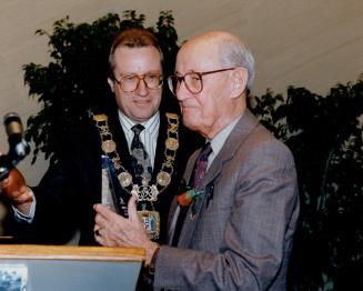 Sporting decision: Veteran Star columnist Milt Dunnell accepts an award from Mayor Art Eggleton yesterday at city hall as Toronto marks its 157th birthday