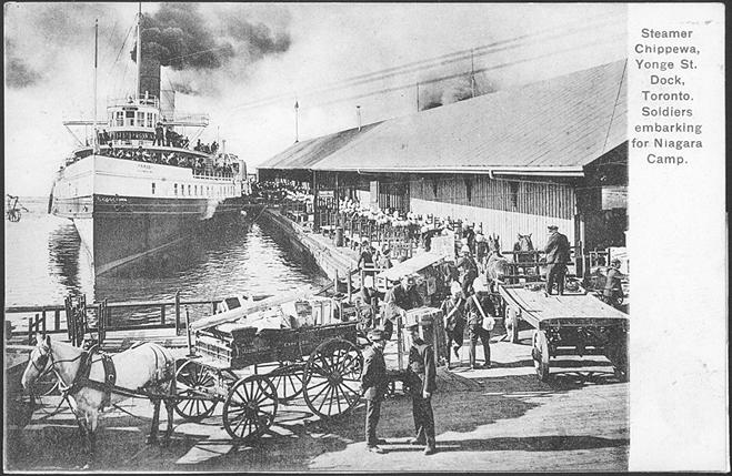 Image shows soldiers embarking on a big ship at the docks.