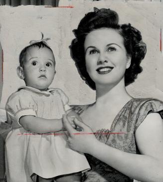 Another Talented Hollywood mother is Winnipeg-born Deanna Durbin, seen with 14 months-old Jessica Louise