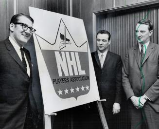 Sign of the times. Lawyer Alan Eagleson (left) and Maple Leafs' Norm Ullman, president of National Hockey League Players' Association, display group's(...)