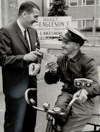 Campaigning for re-election, hockey players' lawyer Alan Eagleson (left) explains hs views to Tommy Greer, a newsdealer for 25 years