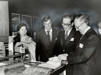 Left to right: Eaton's president Frederik Eaton, Kiyohisa Mikanagi, Japanese ambassador to Canada, and Robert Welch, Ontario's deputy premier, admire silk fabric