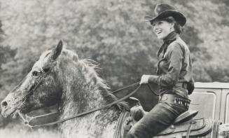 Astride a horse, Samantha Eggar acts out scene in Kleinburg for a futuristic western thriller called Blood City
