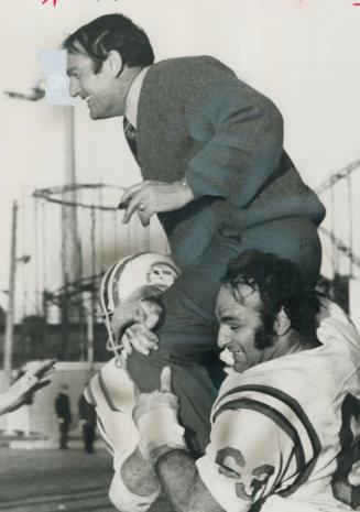 Winner Chaired: Sam Etcheverry, rookie Montreal coach, is carried off field at CNE by happy Terry Evanshen (25) and Pierre Desjardins (63) of Alouettes
