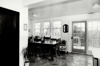 Updated kitchen: Focal point of breakfast area is pine three-board table, now surrounded by pressback chairs, made by Brenda Eggleton's great-grandfather