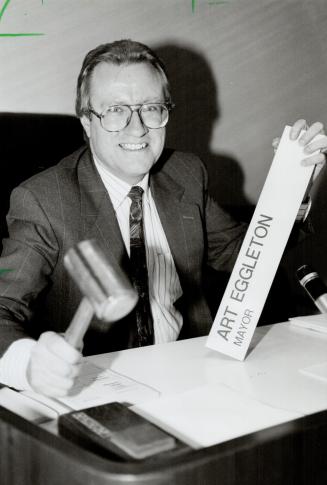 Sing of the times: Art Eggleton packs up his nameplate and gives one final bang of the gavel yesterday as he leaves city hall after 22 years - 11 as mayor