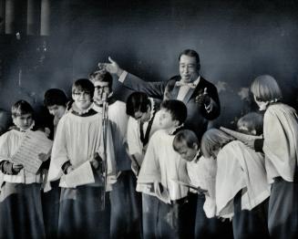 Jazz musician Duke Ellington, surrounded by Anglican choir boys at St