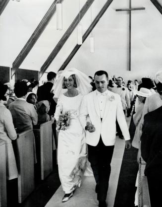 Ron Ellis part of new team. Maple Leaf hockey player Ron Ellis with his bride, the former Janis Greenlaw, leave Rexdale United Church, after their wed(...)