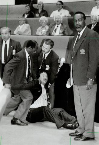 Out of order: Security officers drag Toronto Councillor Steve Ellis from council chambers after he handed out Stop MVA buttons