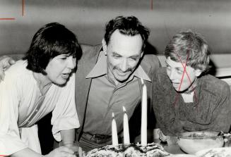 Birthday boy: Sculptor Kass Eloul, with help from his wife, artist Rita Letendre, blows out three large candles on his 60th birthday cake