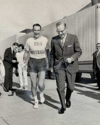 Matching strides, Mayor Bill Dennison (right) keeps in step with Bill Emmerton as the Aussie runner departs on a run today from Toronto's city hall to Expo
