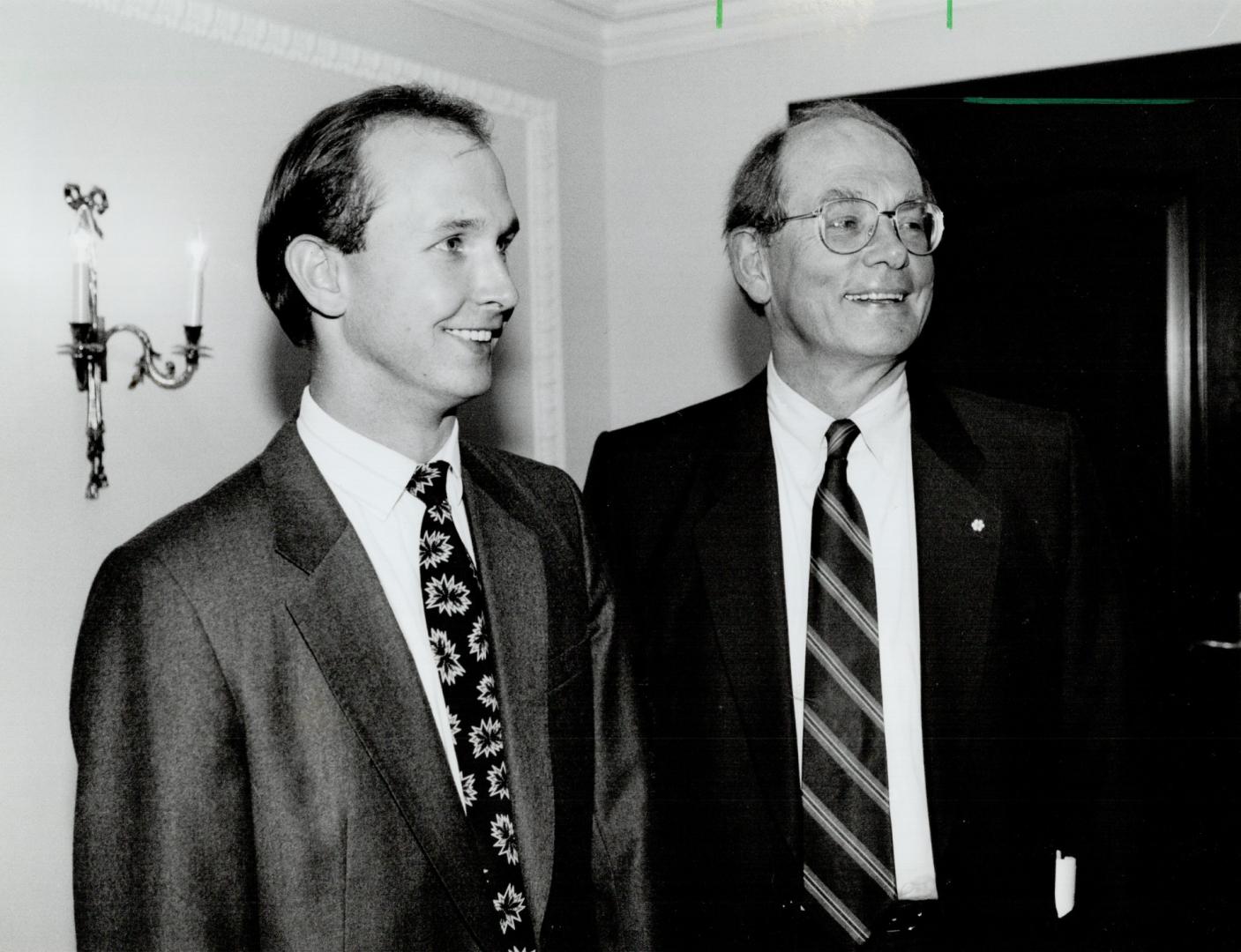 Proud of pop: Son Adam, 26, shares the moment as Trevor Eyton's appointment to the Senate is announced last September