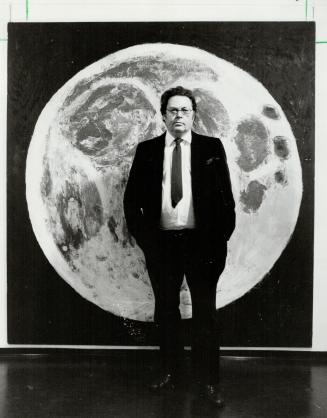 Shining subject. Artist Paterson Ewen stands with his gouged wood, Full Moon, part of his current exhibition. With his monumental pieces, we don't so much see landscape but feel it