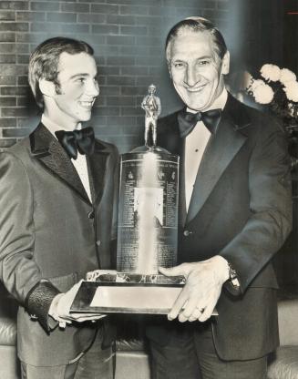 Pair in the winner's circle. Jockey Jeff Fell (left) receives the Joe Perlove Memorial Trophy from The Star's managing editor, Ray Timson, at Constell(...)