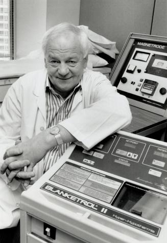 Tumor specialist: Dr. Rudy Falk, beside ba machine that helps destroy cancer cells with heat, treats 30 to 50 terminally ill patients day at his private clinic