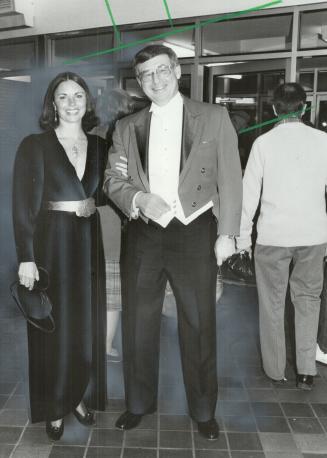 Couture elegance: Judy Pierson, right, with businessman Bernie Faloney wears a black velvet Oscar la Renta gown