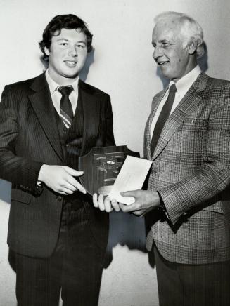 King Feraday. Dan Feraday, U of T Blues' quarterback, was honored last night as the school's outstanding male athlete. Ian Clark (right) presented the(...)