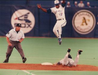 Yikes! Blue Jays shortstop Tony Fernandez made sure he was out of th eway when an untrussed chicken suddenly appeared